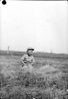 Boy-sitting-in-field.jpg