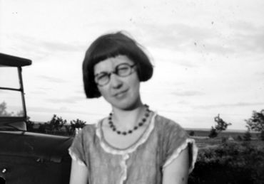 Girl in glasses, dark beaded necklace.jpg