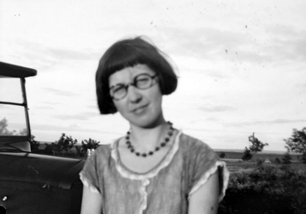 Girl in glasses, dark beaded necklace.jpg