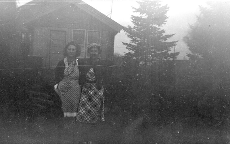 File:Two-women-posing-in-front-of-house.jpg
