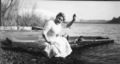 Helene, sitting on canoe, undated.jpg