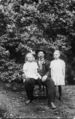 Father-and-daughters-in-front-of-lilac-bushes.jpg