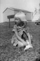 Girl-sitting-in-yard-1950s.jpg